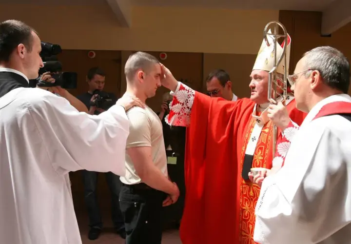 Biskup udziela sakramentu bierzmowania dorosłemu. Warto wiedzieć, ile kosztuje bierzmowanie dla dorosłych, choć cena jest symboliczna.